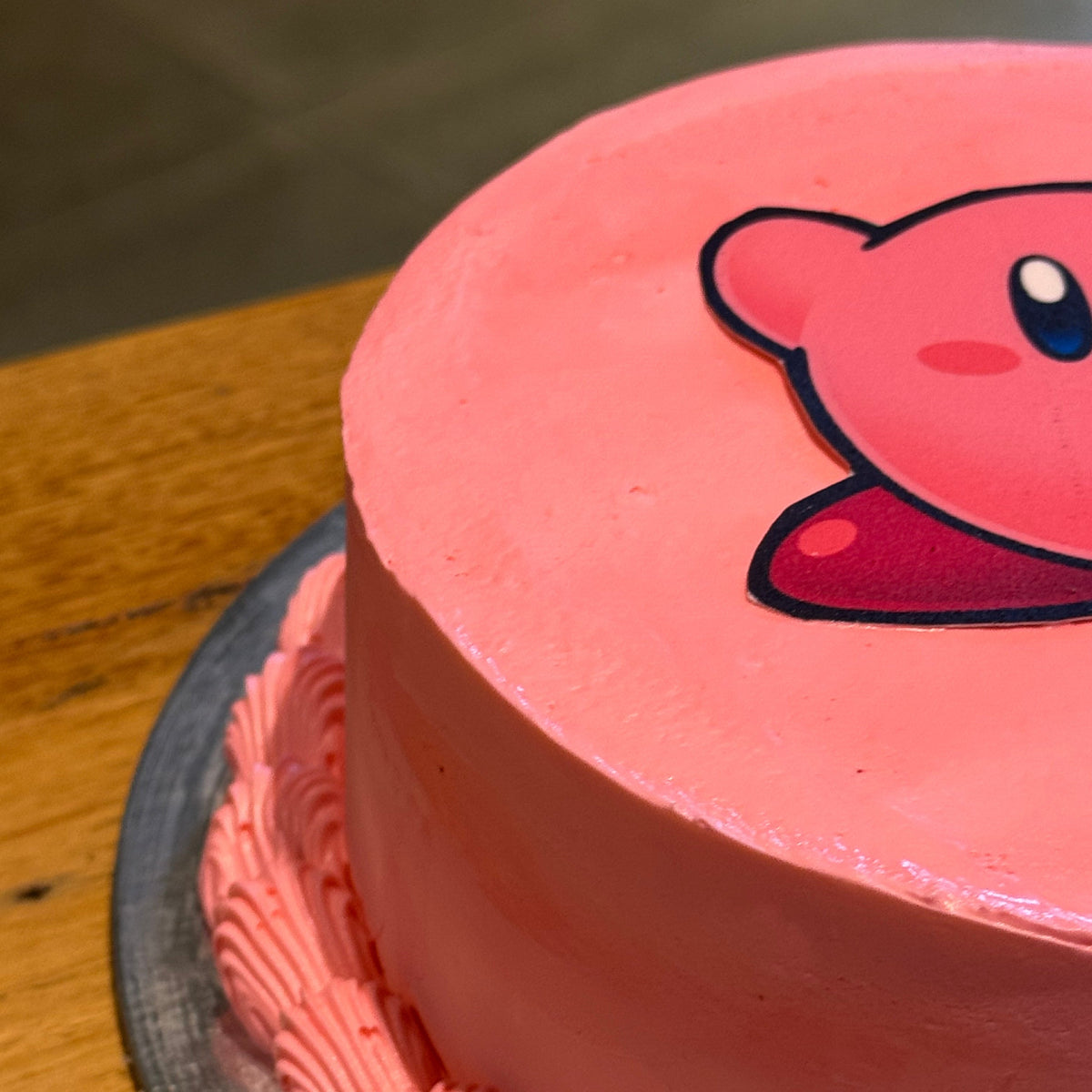 Close-up of Kirby-inspired facial details on a birthday cake handcrafted in Adelaide using Ben & Jerry's ice cream.