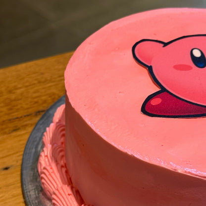Close-up of Kirby-inspired facial details on a birthday cake handcrafted in Adelaide using Ben & Jerry's ice cream.