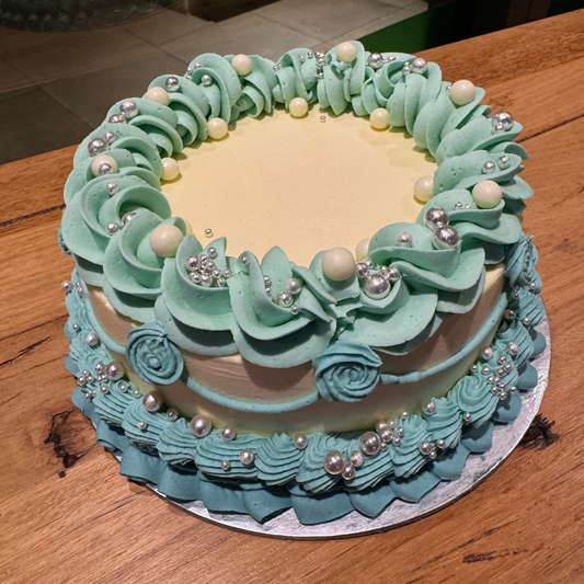 Full view of a retro vintage blue birthday cake handcrafted in Adelaide using Ben & Jerry's ice cream, featuring elegant pearl-inspired decorations.