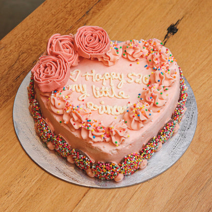 Full view of a heart-shaped roses birthday ice cream cake featuring romantic floral decorations for a special celebration.