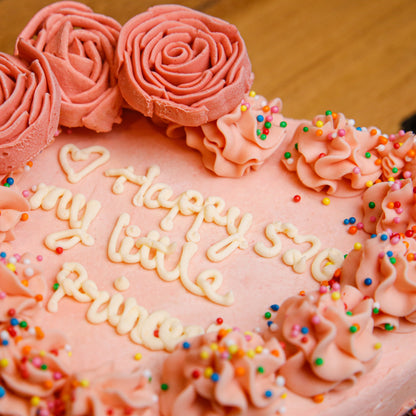 close up of a handcrafted roses heart ice cream cake showcasing its floral-inspired decorations and romantic design.