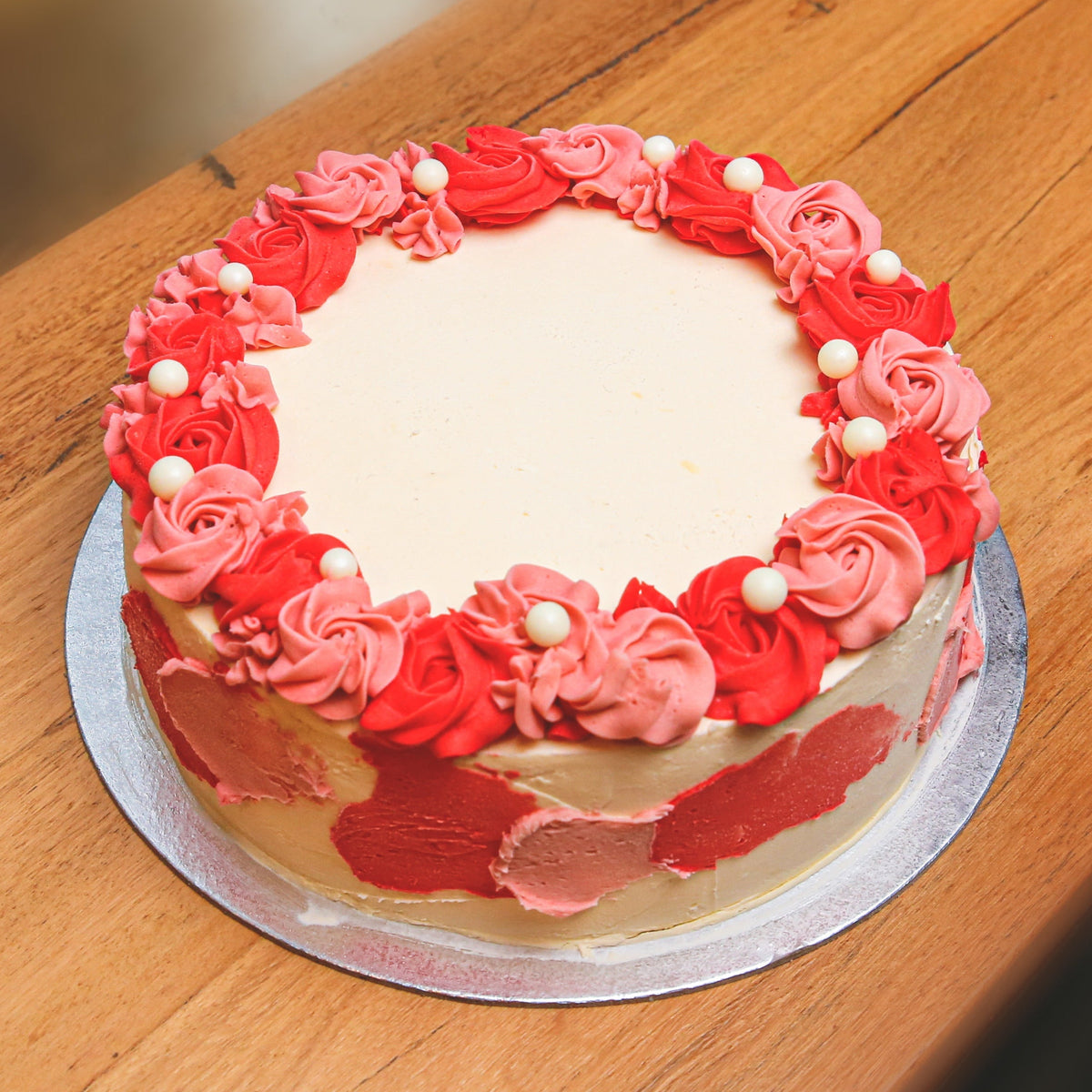 Full view of a Roses and Pearls birthday ice cream cake featuring elegant rose decorations and delicate pearl-inspired accents.