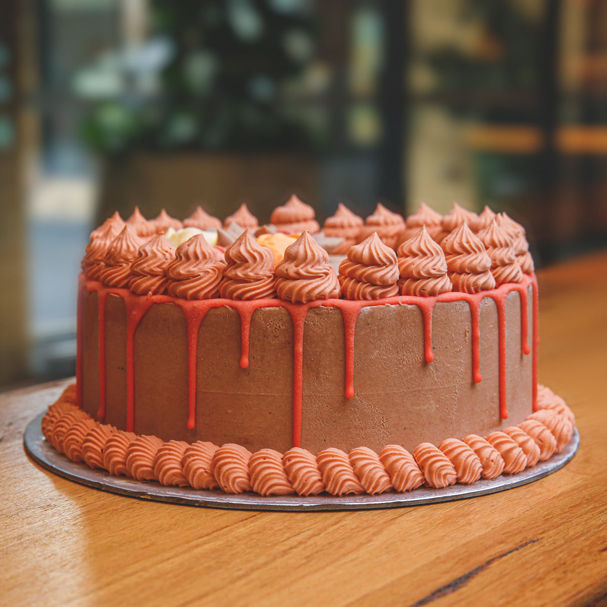 side view of a handcrafted roses birthday ice cream cake showcasing its decorative rose-inspired floral design.