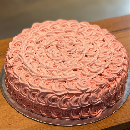 Full view of an elegant rosette birthday cake handcrafted in Adelaide using Ben & Jerry's ice cream, featuring beautiful floral-inspired decorative piping.