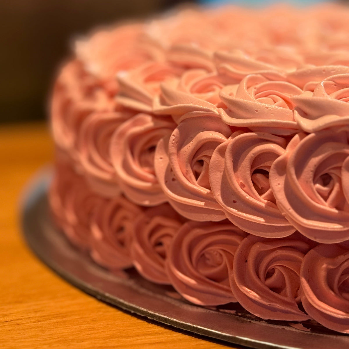 side view of a rosette birthday cake made with Ben & Jerry's ice cream in Adelaide, showcasing its delicate rose-shaped decorative styling.