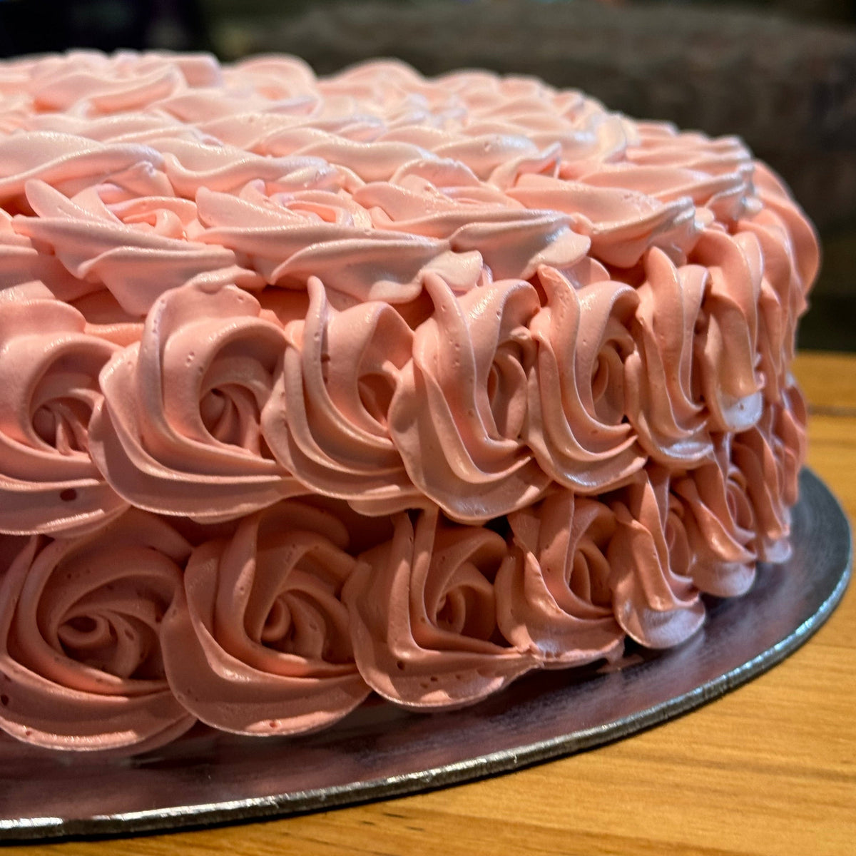 Side view of a handcrafted rosette ice cream cake made using Ben & Jerry's ice cream in Adelaide, highlighting its textured floral-inspired finish.