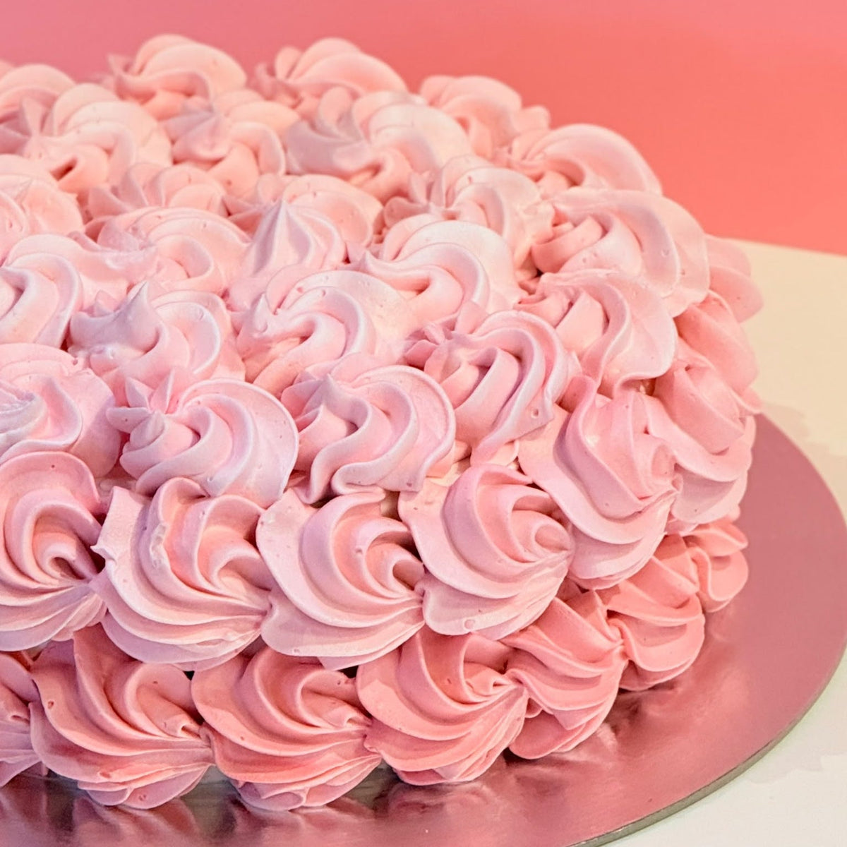 side view of a rosette birthday cake made with Ben & Jerry's ice cream in Adelaide, showcasing its delicate rose-shaped decorative styling.