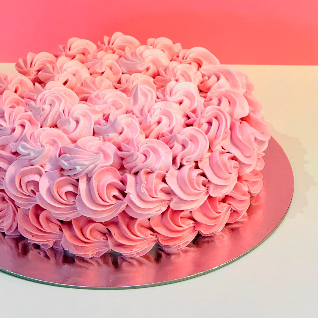 side of the intricate rosette-inspired piping on a birthday cake handcrafted in Adelaide using Ben & Jerry's ice cream.