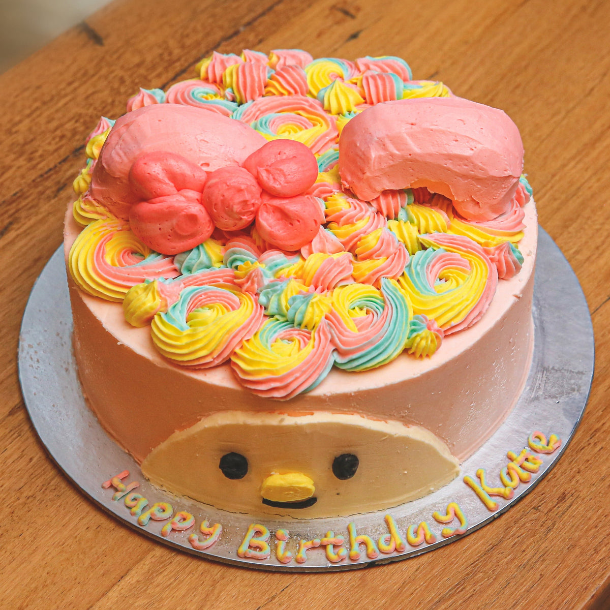 top view of a Sanrio My Melody birthday ice cream cake featuring the adorable pink-hooded character in a kawaii-inspired design.