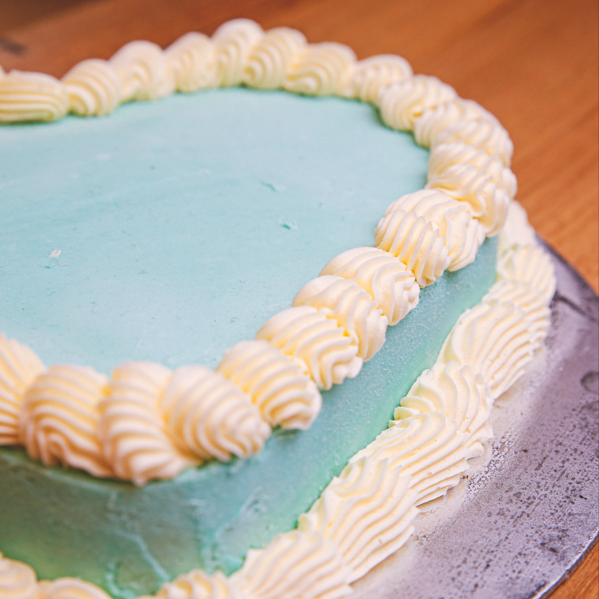 close up of a handcrafted heart-shaped ice cream cake made with Ben & Jerry's ice cream in Adelaide, highlighting its elegant finish.
