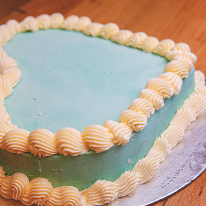 Close-up of the smooth, minimalist decorative finish on a heart-shaped cake handcrafted in Adelaide using Ben & Jerry's ice cream.