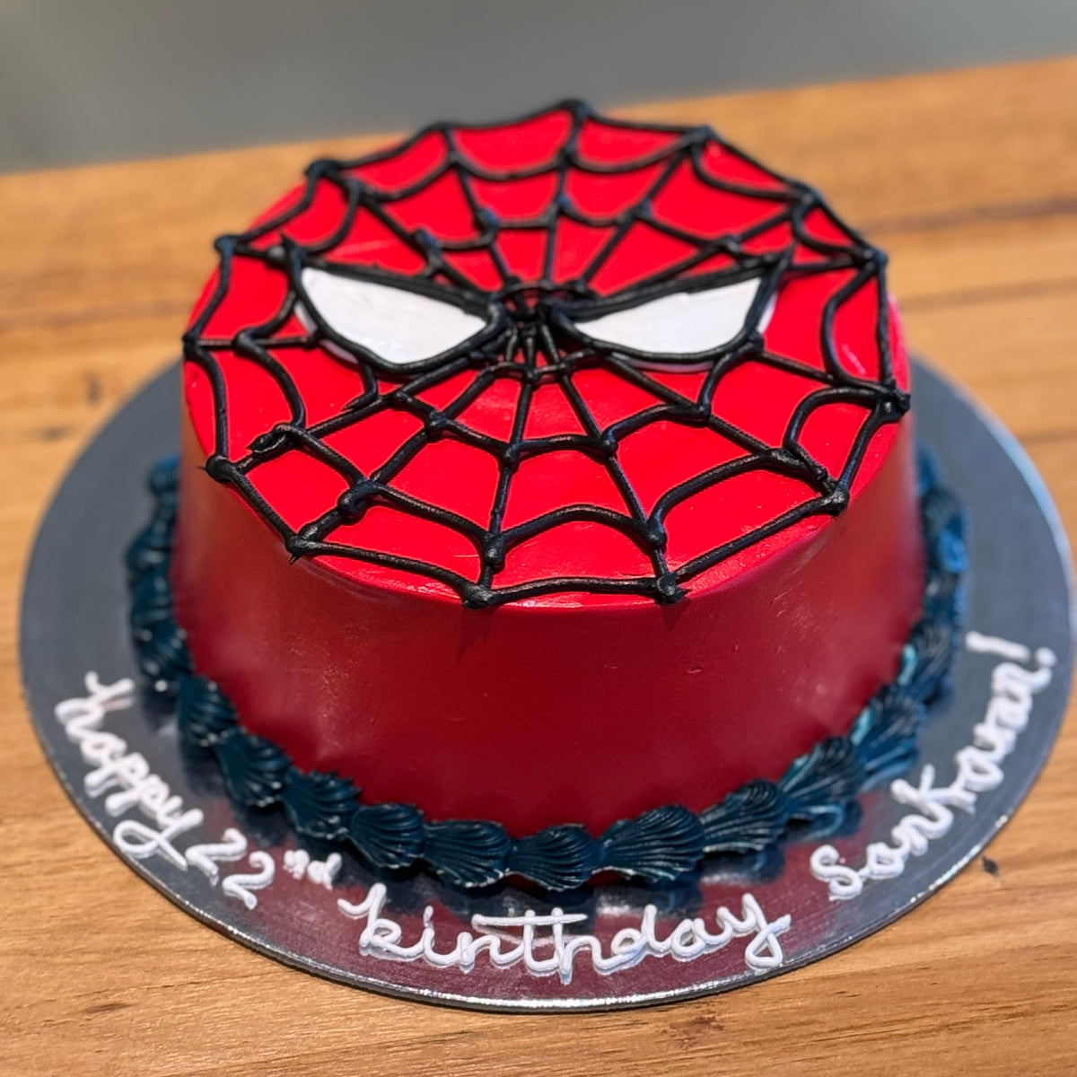 top view of a handcrafted Spiderman ice cream cake made using Ben & Jerry's ice cream in Adelaide, designed for a superhero birthday celebration.