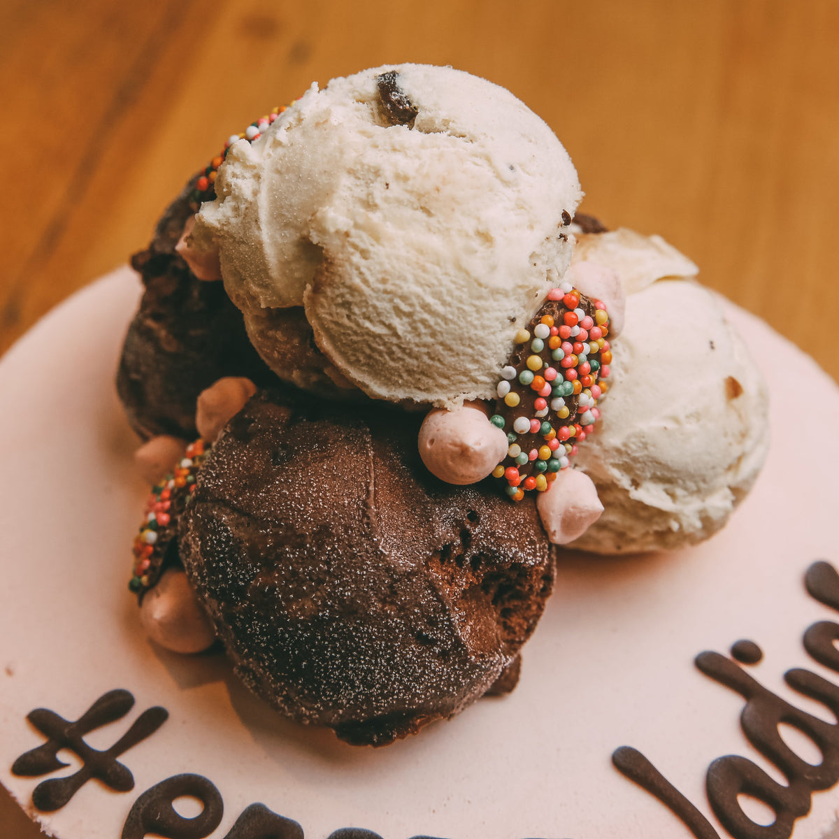 close up of a handcrafted Stacks On birthday cake highlighting its chocolate-loaded toppings and layered decorative arrangement.