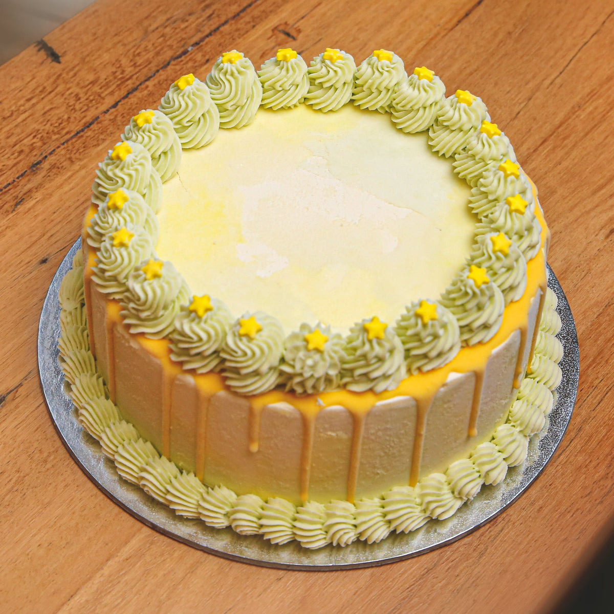 Full view of a green starry night birthday ice cream cake featuring celestial-inspired decorations for a magical celebration.