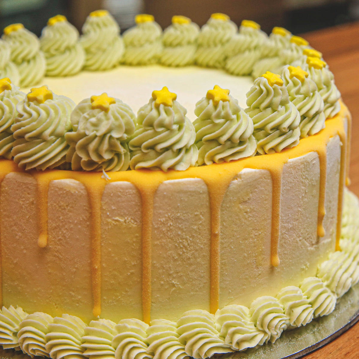 close up of a green starry night birthday cake highlighting its distinctive green colour theme and star-inspired design.