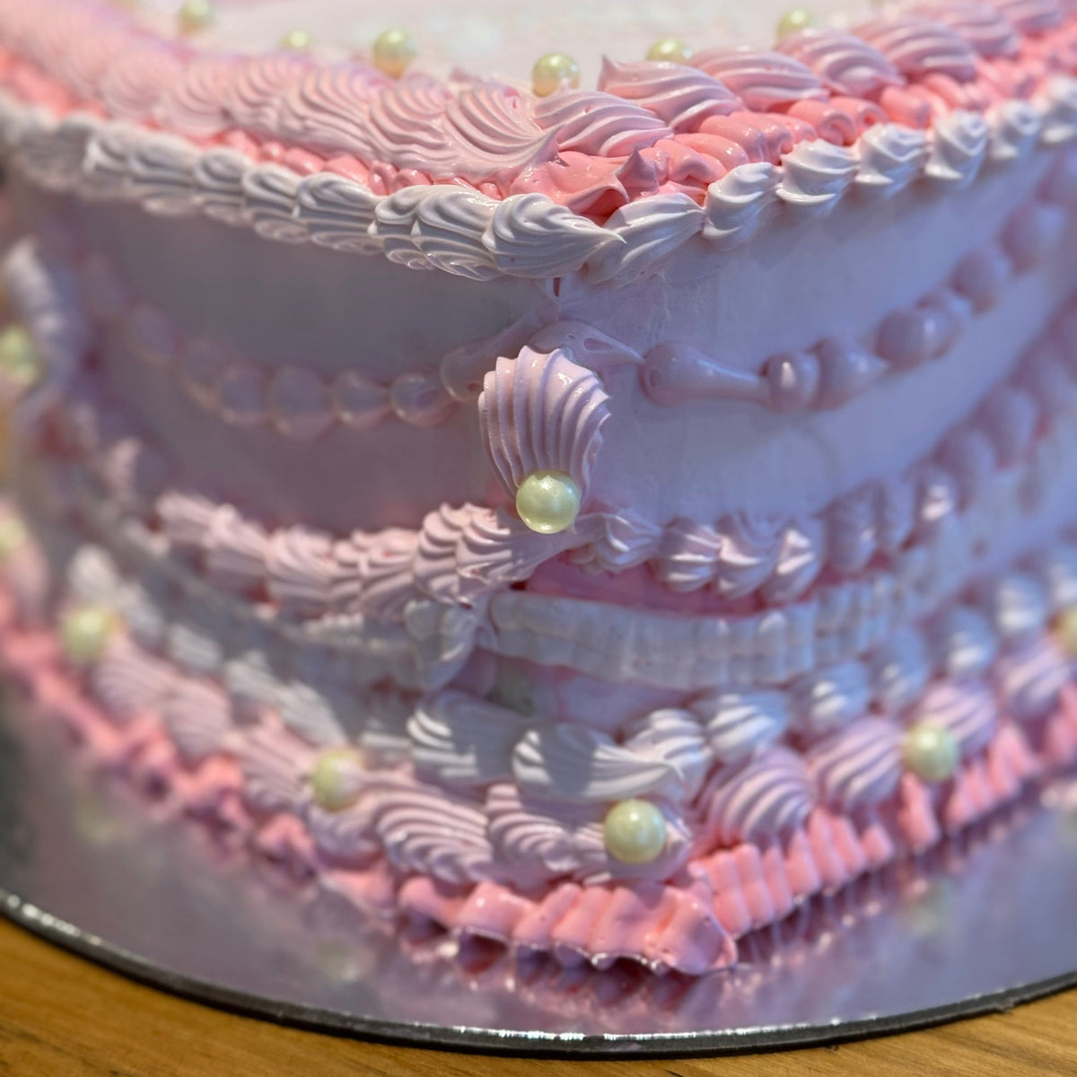close up of a handcrafted vintage heart ice cream cake in Adelaide made using Ben & Jerry's ice cream, highlighting its layered piped details.