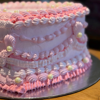 Close-up of intricate vintage-style piping on a traditional heart cake handcrafted in Adelaide using Ben & Jerry's ice cream.