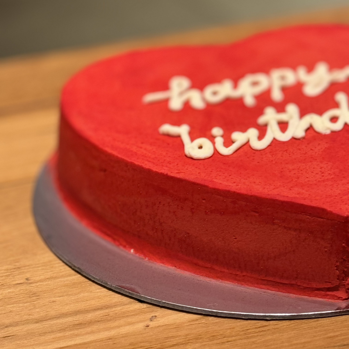 Side view of a handcrafted Valentine's Day heart-shaped cake made with Ben & Jerry's ice cream in Adelaide, highlighting its celebration-ready presentation.