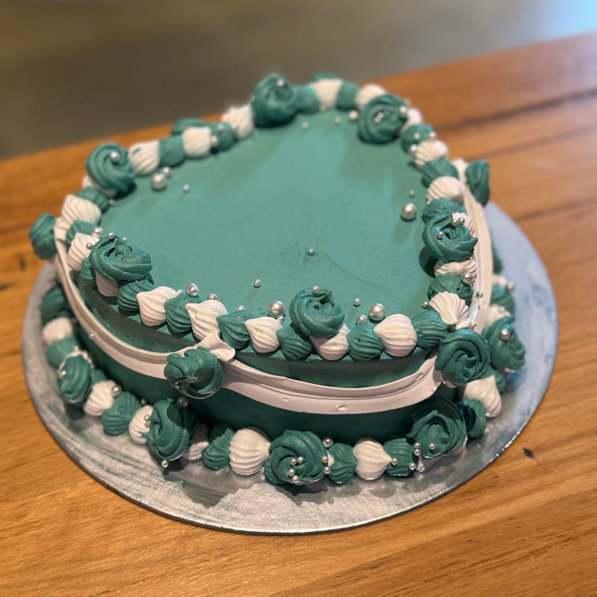Full view of an elegant vintage heart cake handcrafted in Adelaide using Ben & Jerry's ice cream, featuring classic decorative piping.