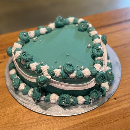 Full view of an elegant vintage heart cake handcrafted in Adelaide using Ben & Jerry's ice cream, featuring classic decorative piping.