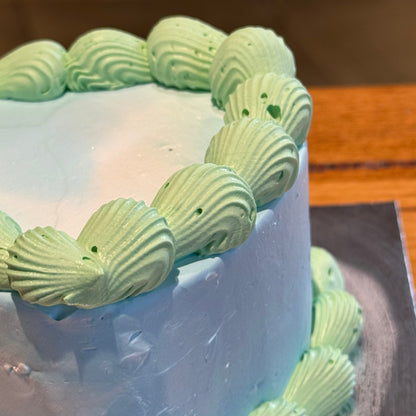 Side view of a retro heart-shaped cake handcrafted in Adelaide using Ben & Jerry's ice cream, highlighting its layered contrast piping.