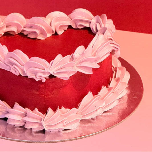 Side view of a heart-shaped vintage ice cream cake handcrafted in Adelaide using Ben & Jerry's ice cream, highlighting its decorative piped borders.