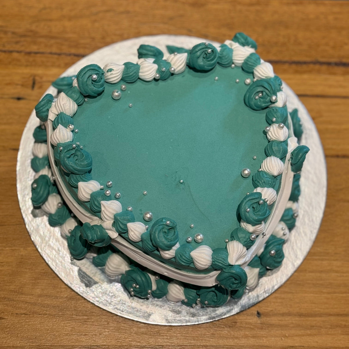top view of a heart-shaped vintage cake made with Ben & Jerry's ice cream in Adelaide, showcasing its traditional piped borders.