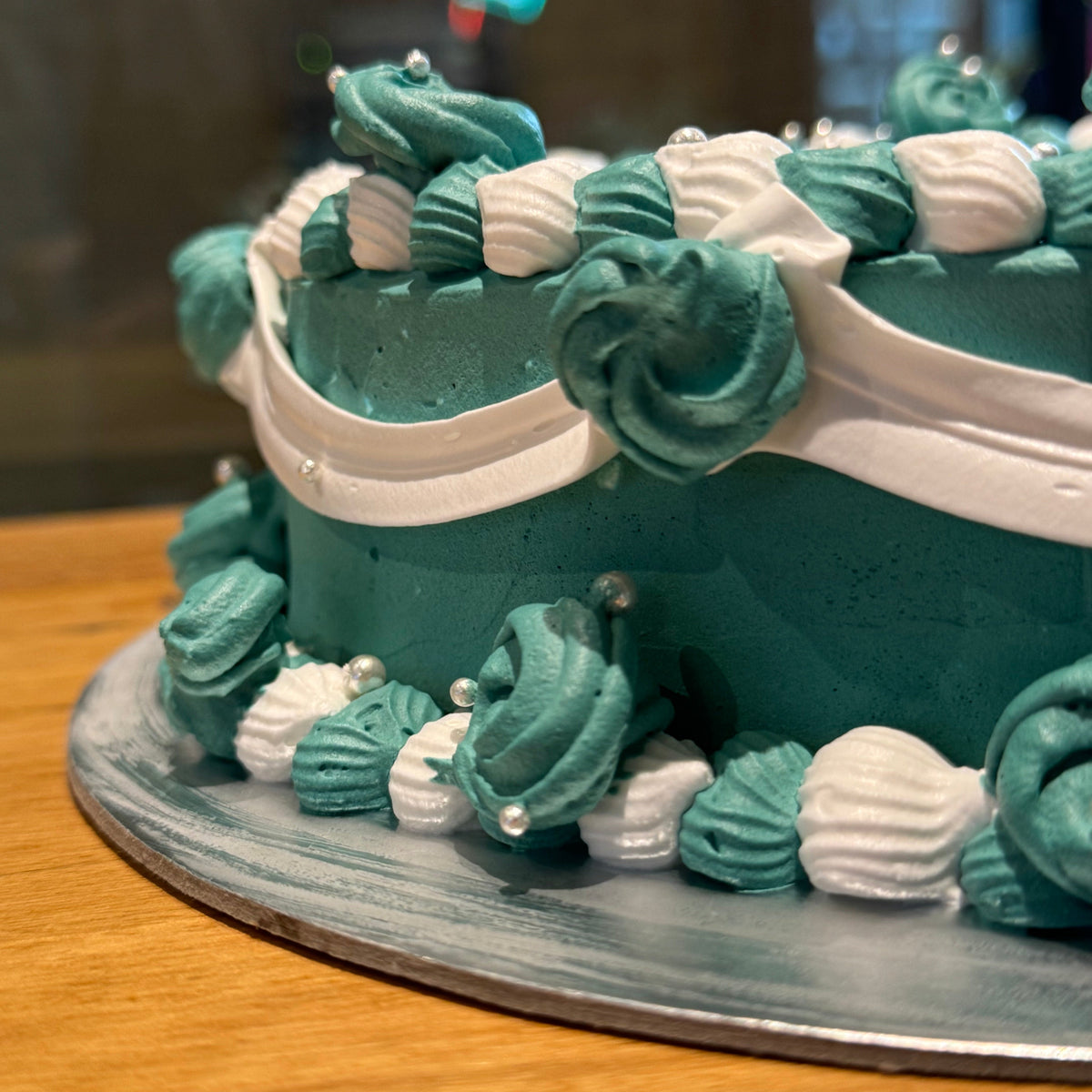 close up of a handcrafted vintage heart ice cream cake in Adelaide made using Ben & Jerry's ice cream, highlighting its decorative piping.