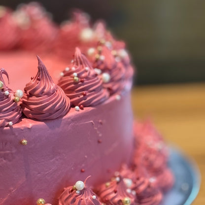 close up of a burgundy-toned vintage ice cream cake handcrafted in Adelaide using Ben & Jerry's ice cream, highlighting its rich colour and decorative finish.