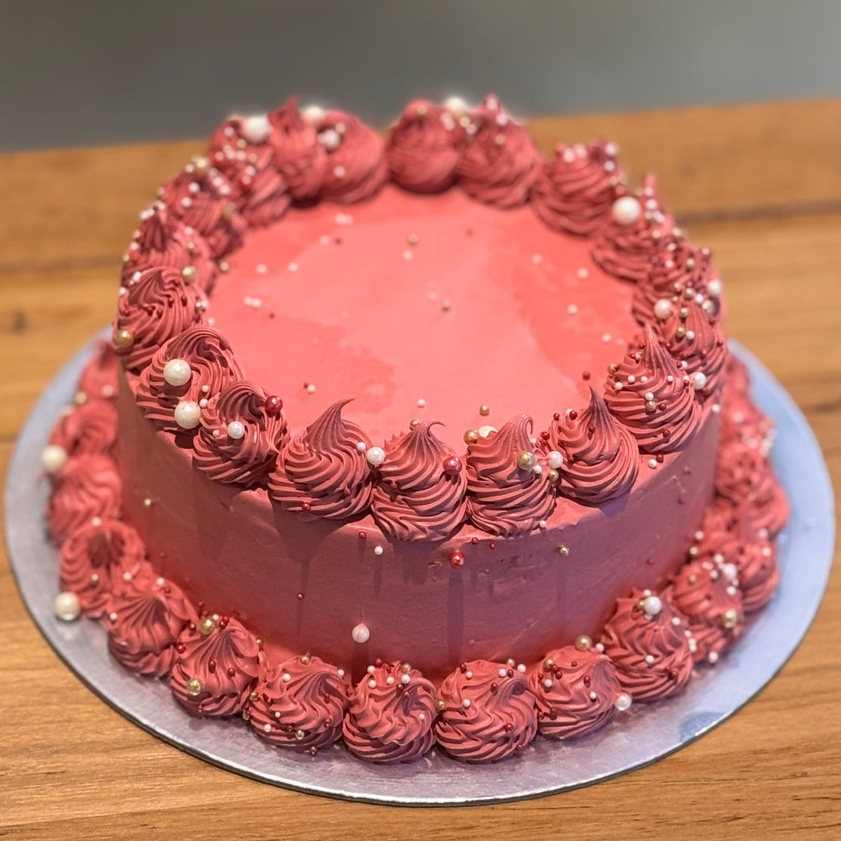 Full view of a vintage maroon birthday cake with pearl accents, handcrafted in Adelaide using Ben & Jerry's ice cream.