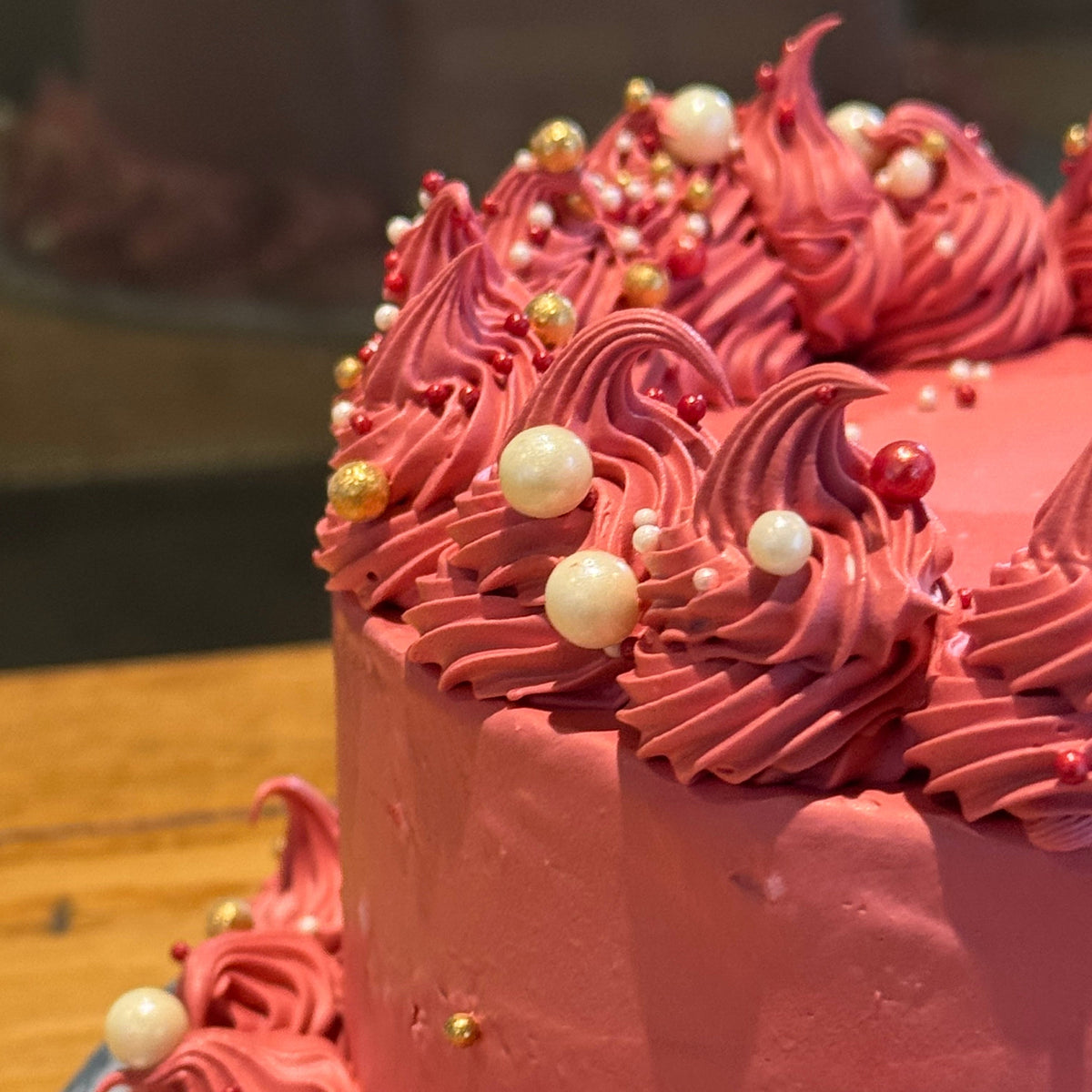 Front view of a maroon vintage cake made with Ben & Jerry's ice cream in Adelaide, showcasing its elegant piping and pearl embellishments.