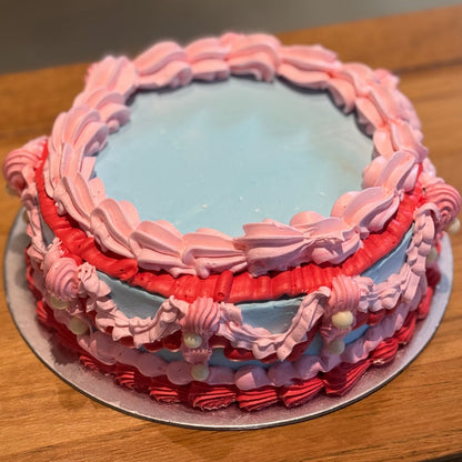 top view of decorative pearl accents and pink, red and blue piping on a vintage cake made in Adelaide using Ben & Jerry's ice cream.