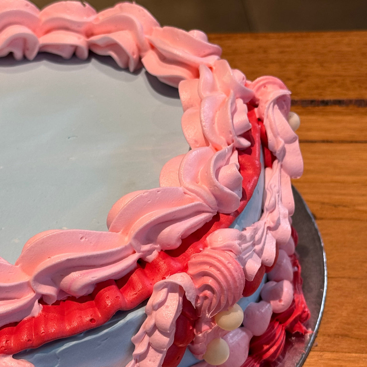 close up of a vintage ice cream cake handcrafted in Adelaide using Ben & Jerry's ice cream, highlighting its vibrant colour combination.