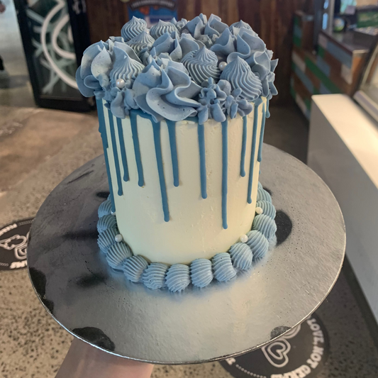 Full view of a tall blue vintage birthday cake handcrafted in Adelaide using Ben & Jerry's ice cream, featuring elegant pearl-inspired decorations.