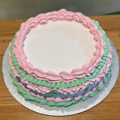 top view of a vintage ice cream cake handcrafted in Adelaide using Ben & Jerry's ice cream, highlighting its white base and soft pink accents.