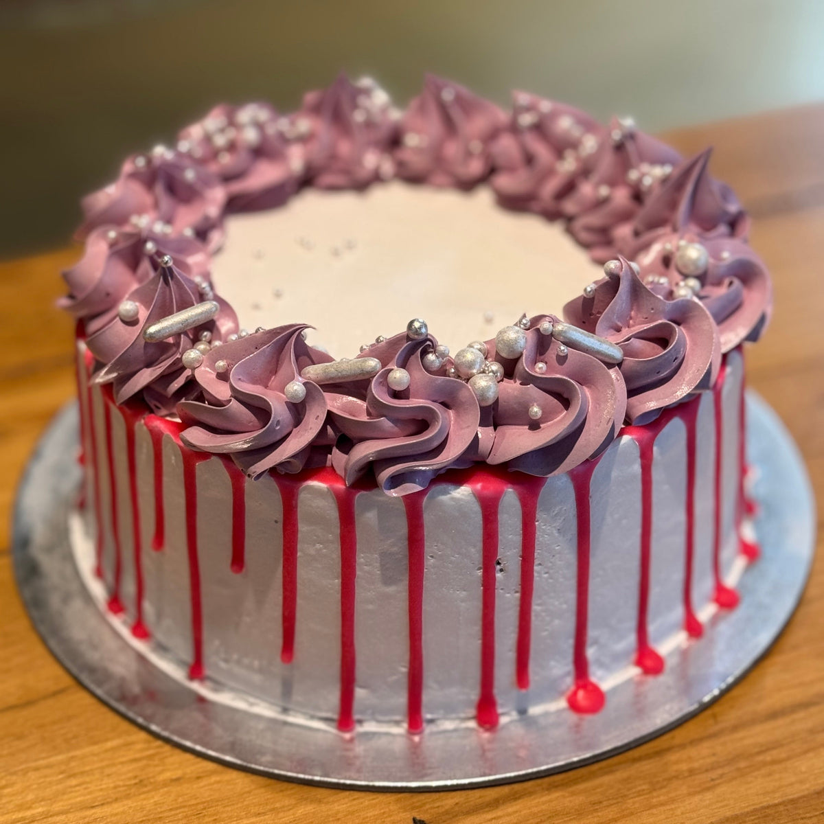 Full view of a vintage white, pink and purple birthday cake with pearl accents, handcrafted in Adelaide using Ben & Jerry's ice cream.