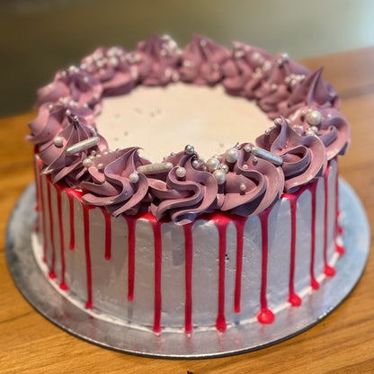 Full view of a vintage white, pink and purple birthday cake with pearl accents, handcrafted in Adelaide using Ben & Jerry's ice cream.