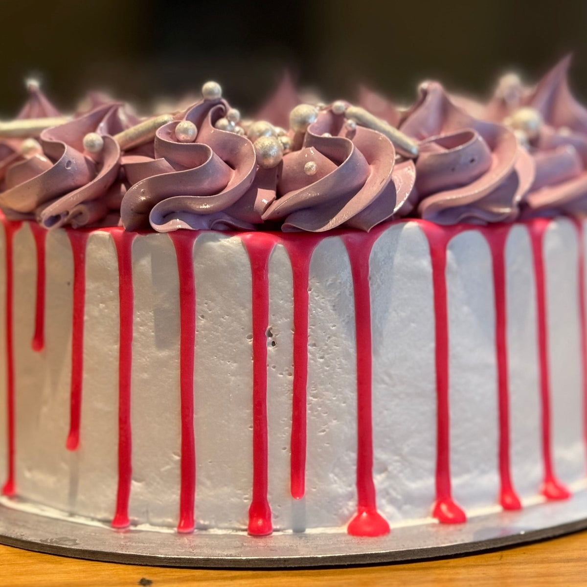 front view of delicate piping and pearl decorations on a white, pink and purple vintage cake made in Adelaide using Ben & Jerry's ice cream.