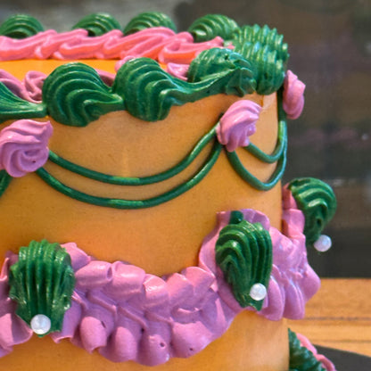 Close-up of green, orange and pink vintage-style piping on a colourful birthday cake handcrafted in Adelaide.