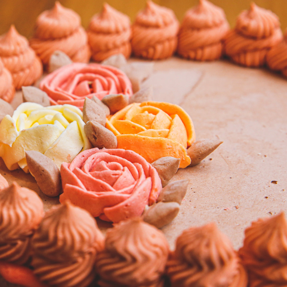 close up of a roses ice cream cake highlighting its floral-inspired decorations and elegant celebration cake finish.